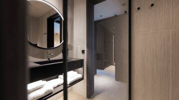 Une salle de bain moderne avec un meuble-lavabo foncé, un miroir rond et une cabine de douche en verre.