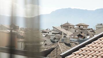 A view of a town with traditional buildings and a mountain in the background.