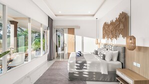 A modern bedroom with a large bed, a bedside table, and a view of the outdoors. - Kana Village Villa by Kozystay (Tabanan)