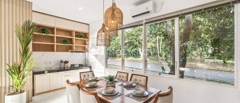 A modern kitchen with a dining area.