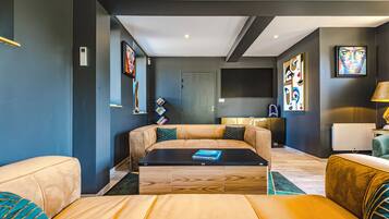 Een moderne woonkamer met een bank, salontafel en kunst aan de wanden.