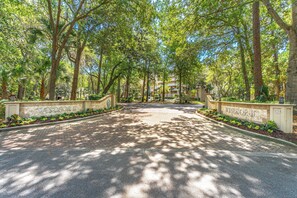 A paved driveway leading to a building with a sign reading 'Windsor II'. - Oceanfront Palmetto Dunes Villa w/ Balcony, King Suite & Stunning Views (Hilton Head Island)