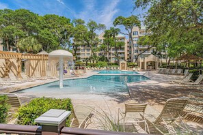 A pool area with lounge chairs and a water fountain. - Oceanfront Palmetto Dunes Villa w/ Balcony, King Suite & Stunning Views (Hilton Head Island)