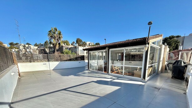 A rooftop terrace with a glass enclosure, a tiled floor, and a view of the surrounding neighborhood. - Spacious Penthouse-5 Rooms apartment in Best location  (Jerusalem)