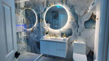 Shower, hair dryer, towels, shampoo