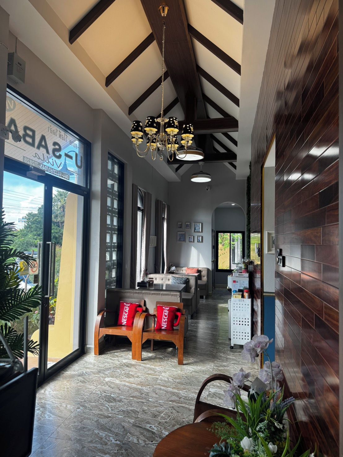 A modern interior with a dining area, a bar, and a seating space with a view.