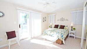 A bedroom with a bed, a chair, a nightstand, a ceiling fan, and a window with blinds. - Coral Ridge 1-Oceanside 78th St, Free WiFi, W/D, AC (Ocean City)