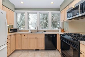 Fridge, stovetop, dishwasher, coffee/tea maker