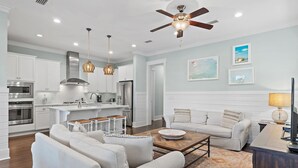 A modern kitchen with white cabinetry, stainless steel appliances, and pendant lighting. - Family Tides FREE 6-Seater Golf Cart,and 5 Bikes!! 2 Resort Pools, Pickleball Courts (Santa Rosa Beach)
