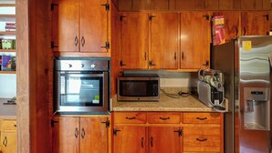 A kitchen with wooden cabinets, a stainless steel oven, a microwave, a toaster, and a refrigerator. - Game Room! Serene 15-acre Nature Escape in Delmar (Delmar)