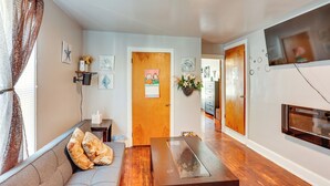 Un salon avec un canapé, une table basse et une cheminée.