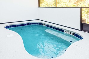 A small indoor swimming pool with blue tiles and depth markers. - Amazing 5BD Family Townhouse at Paradiso Grande (Orlando)