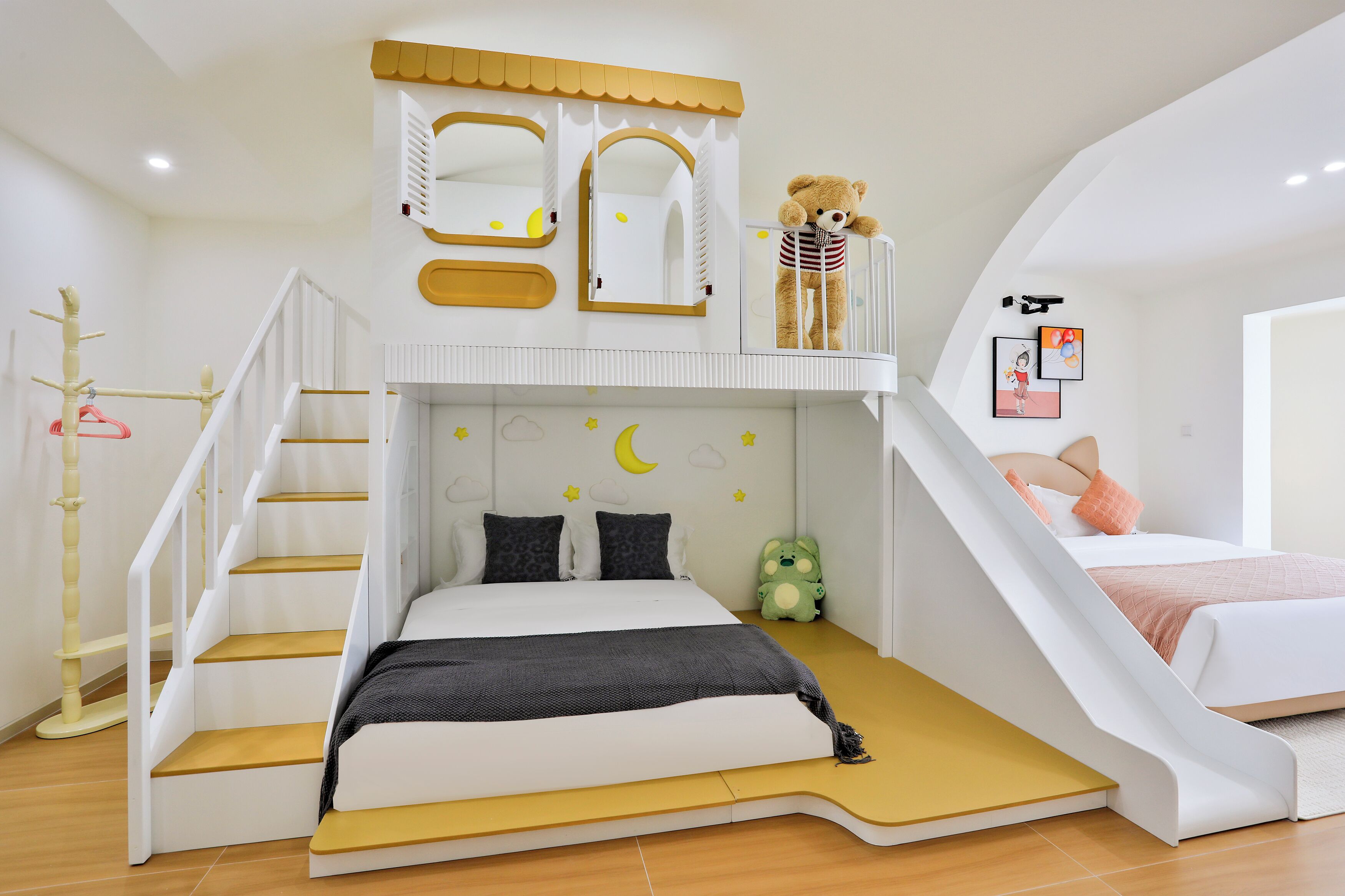 A child's bedroom with a bunk bed, a slide, and a small staircase.