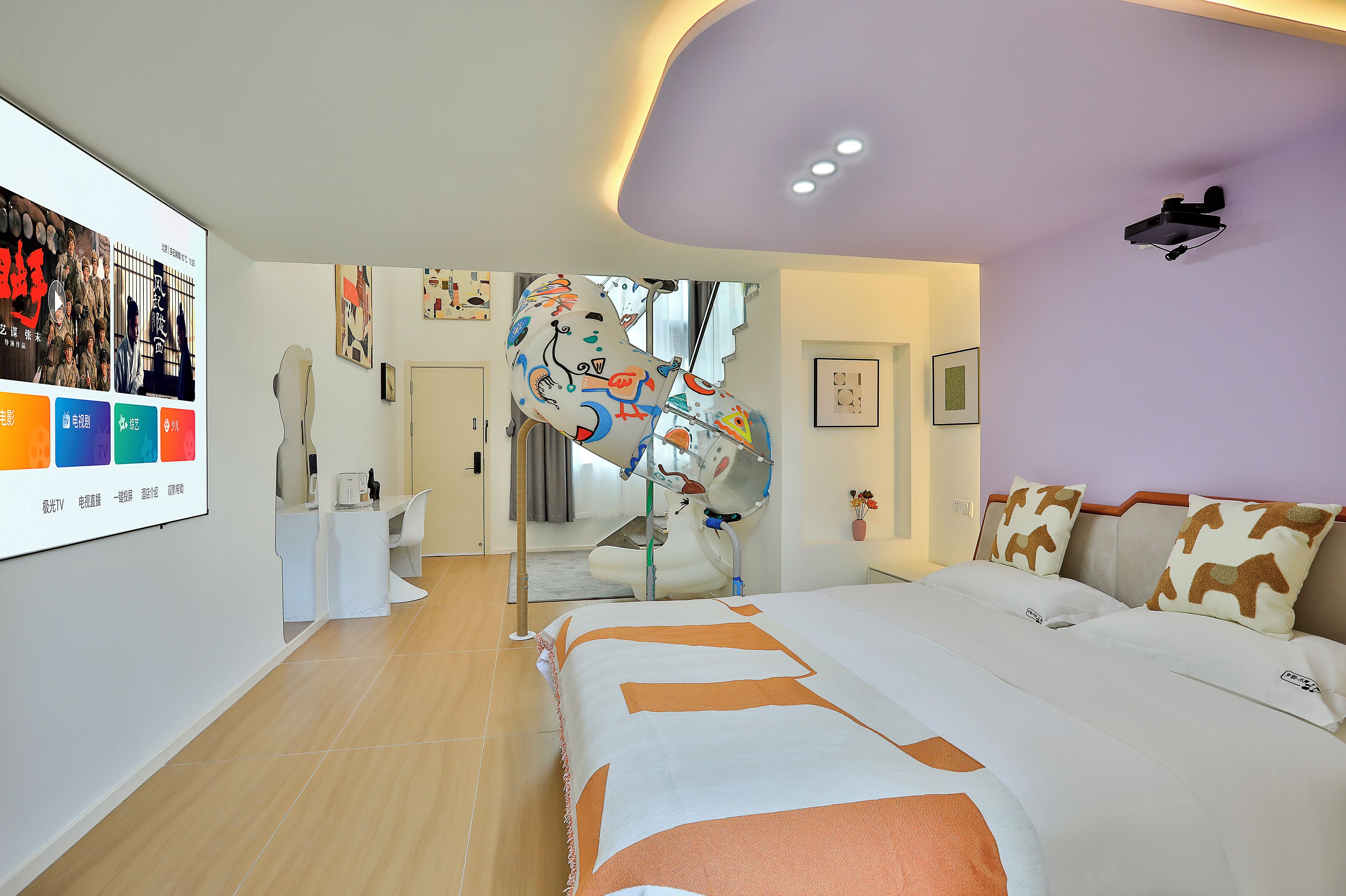 A modern hotel room with a large bed, a desk, and a mirror.