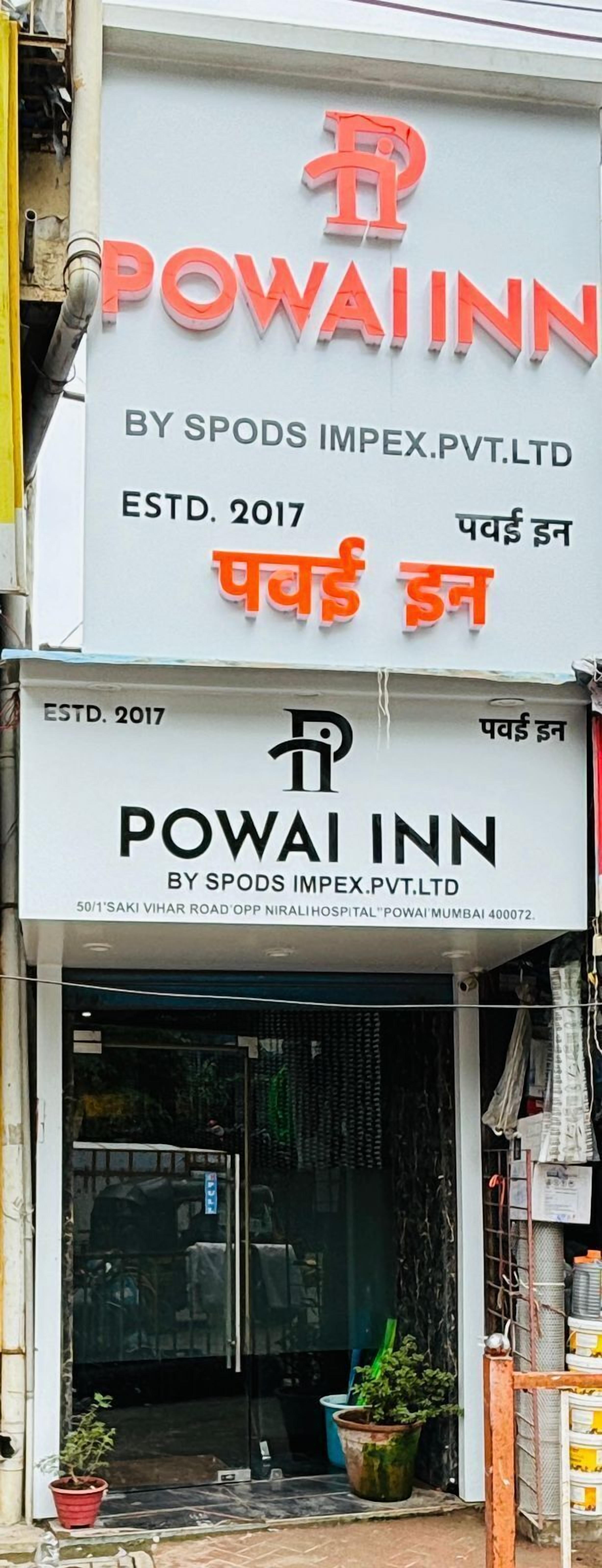 A hotel sign with the name "POWAI INN" and establishment year 2017.