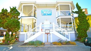 A two-story building with a sign reading "Coral Ridge 7". - Coral Ridge 1 2 Bedroom Condo (Ocean City)