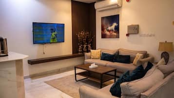 Superior Apartment, City View | Living area | TV