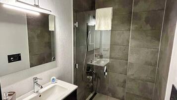 Shower, hair dryer, slippers, towels