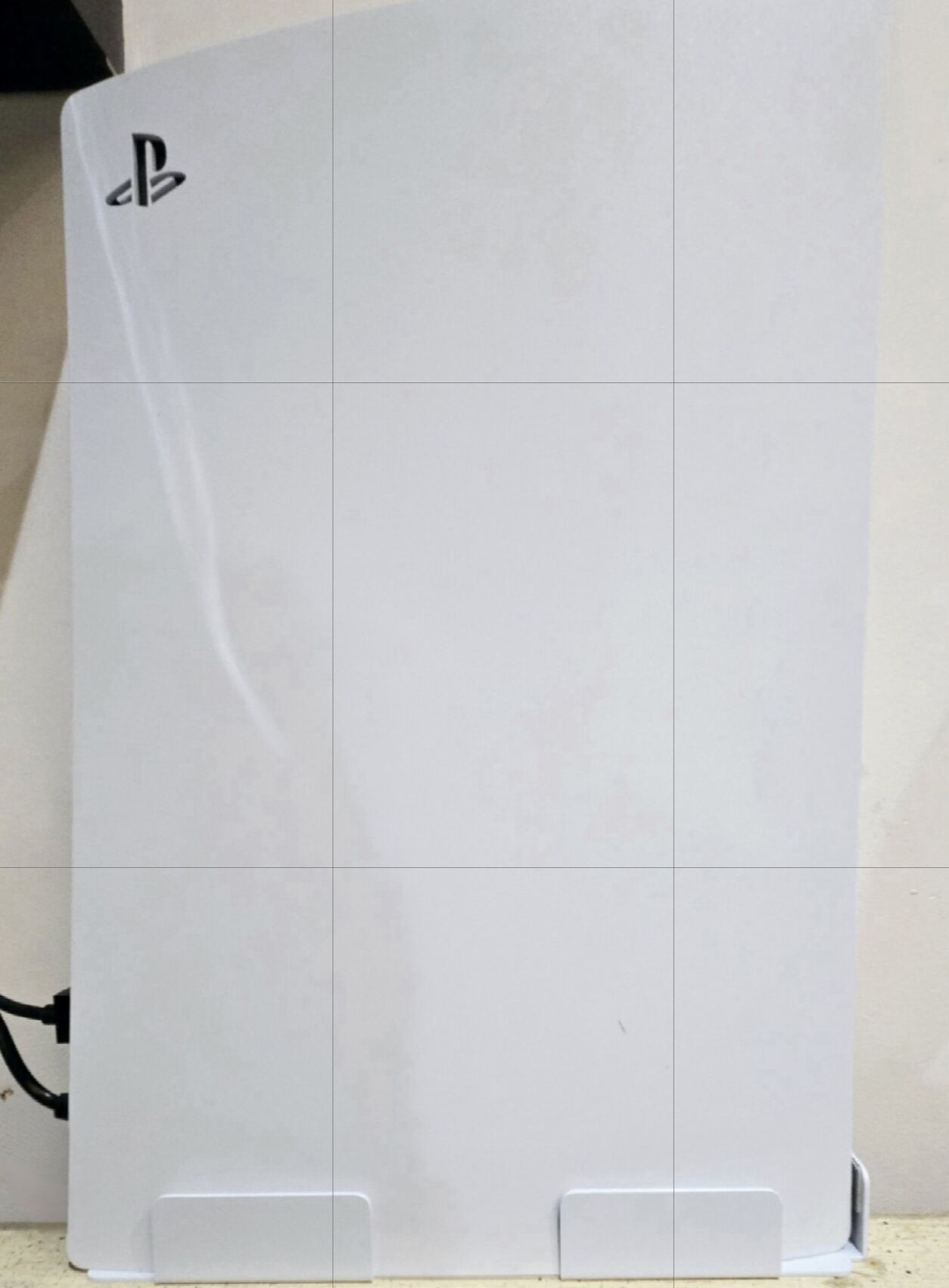 A white, rectangular object with a logo on the top left corner.