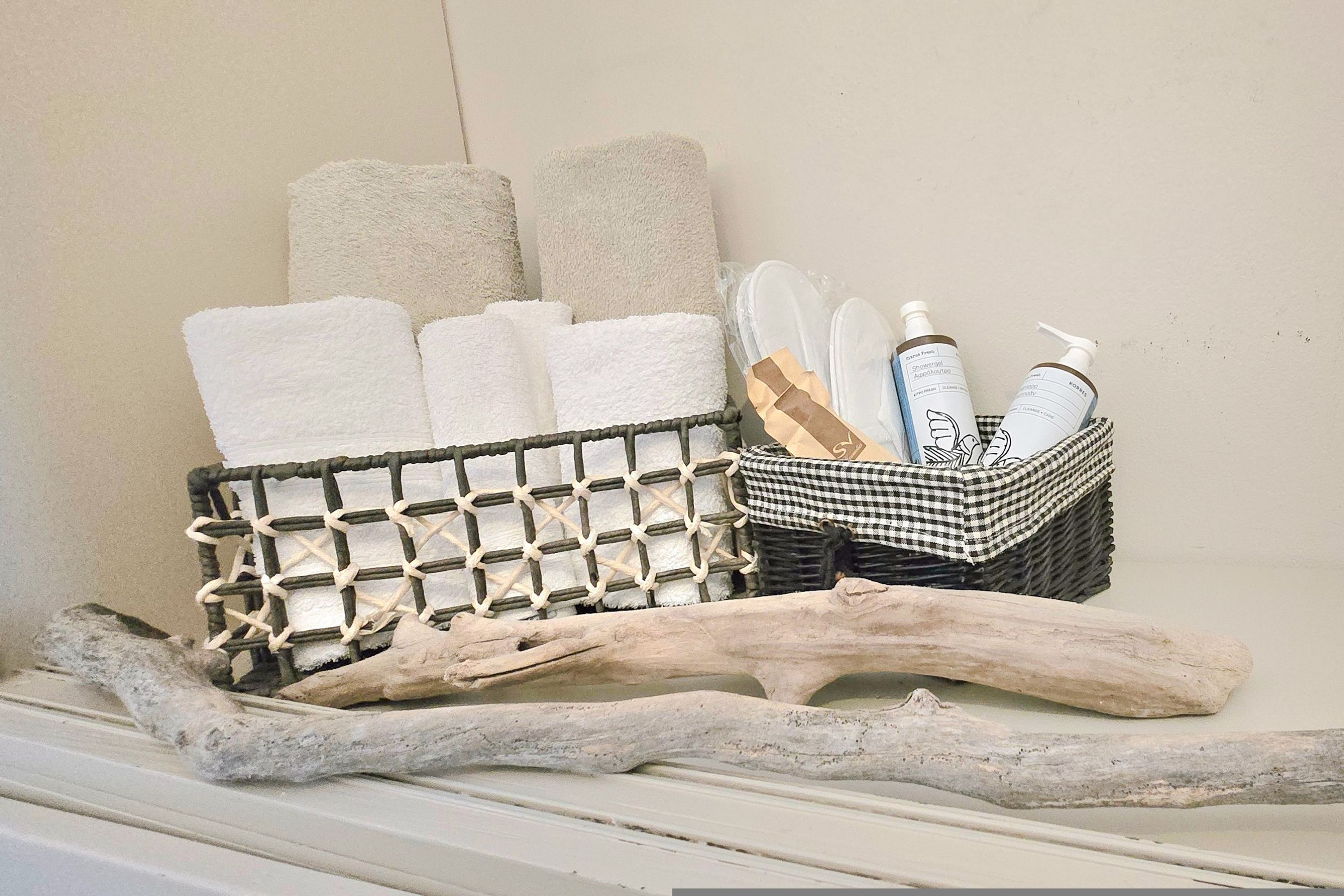 A storage basket with towels and toiletries.