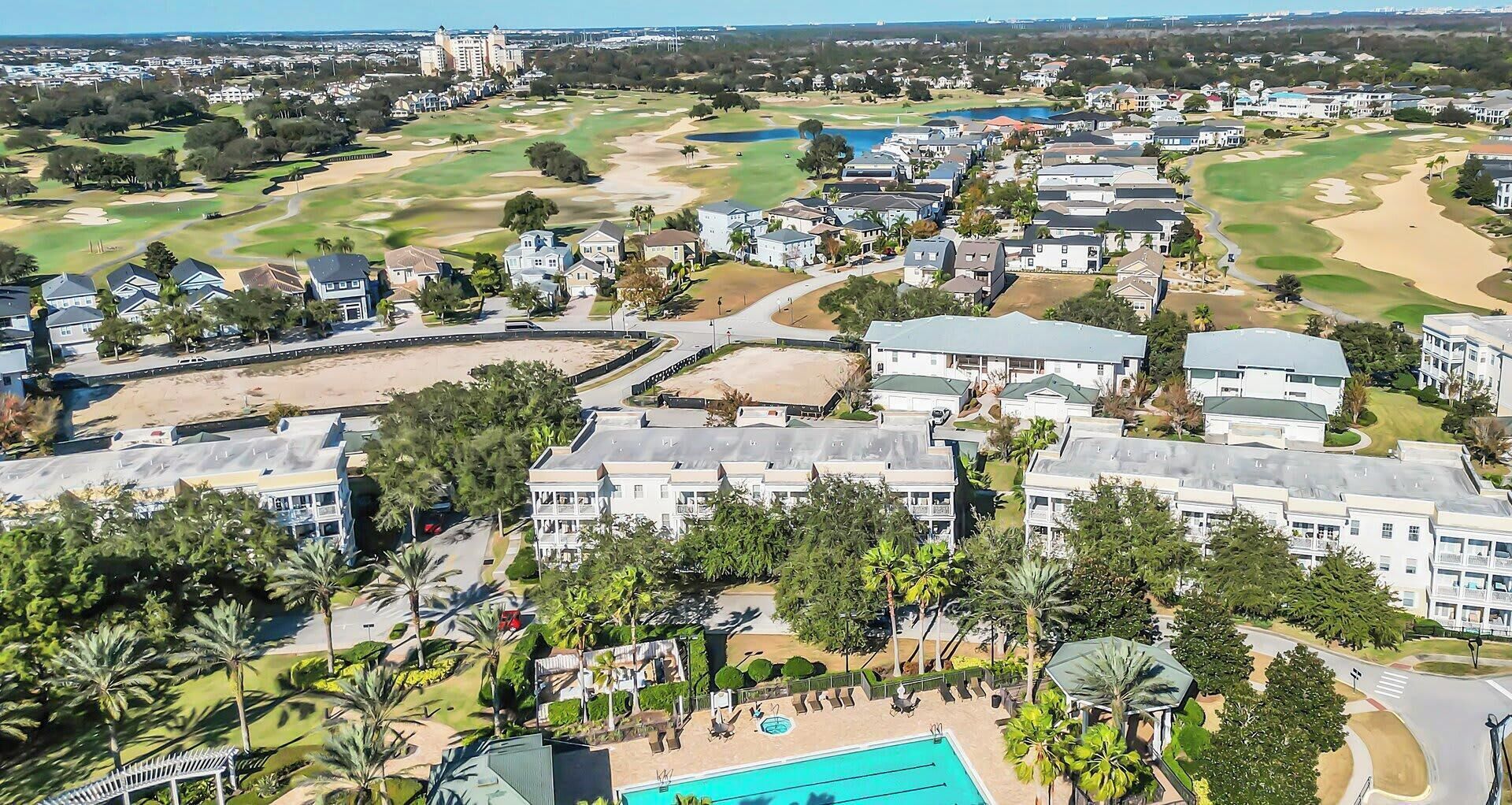 A residential area with houses, a swimming pool, and a golf course.