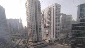 A high-rise residential building complex with multiple apartment buildings, a central courtyard, and a parking area. - Hassani (Dubai)