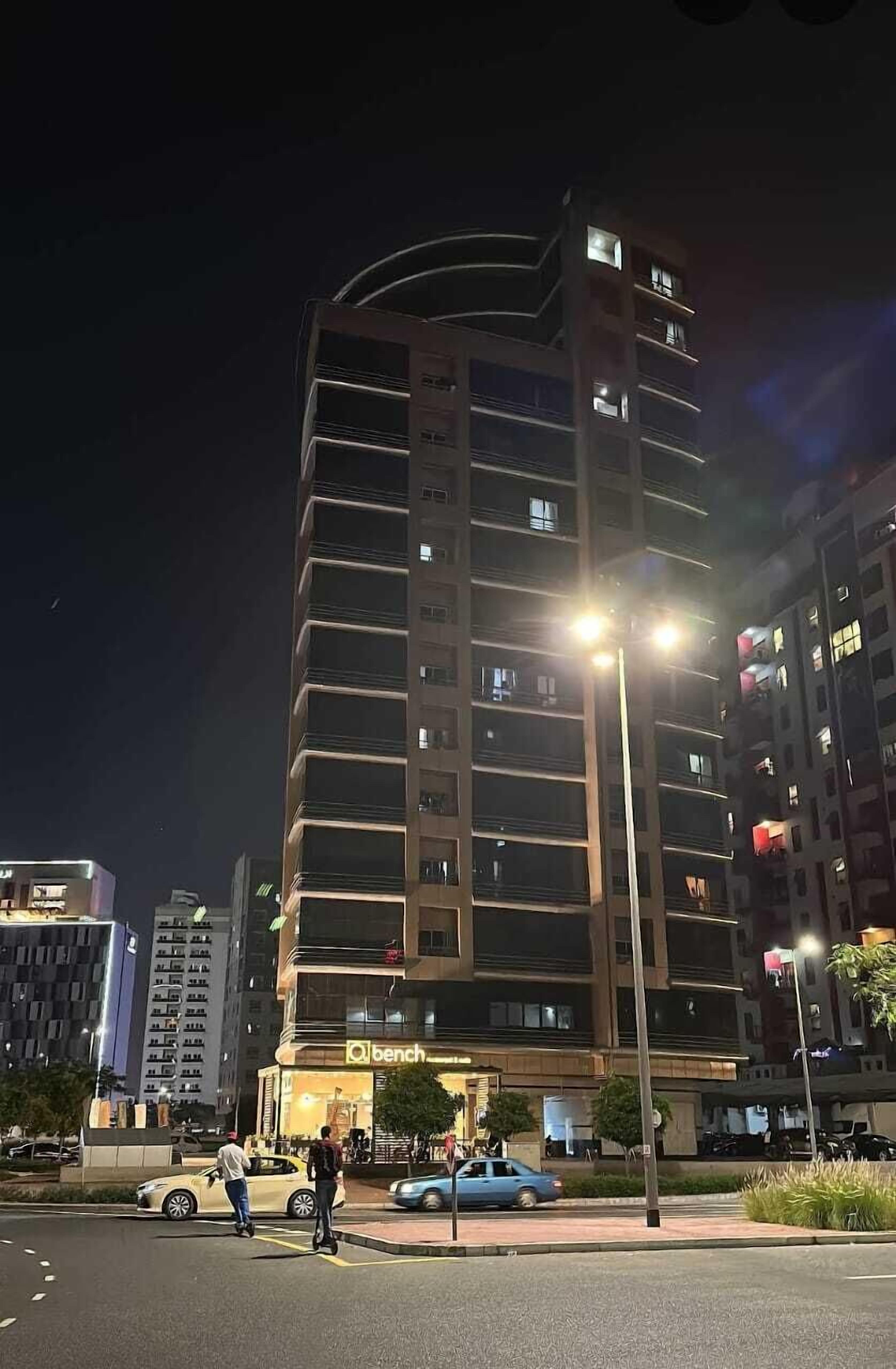 A multi-story building with a 'bench' sign at the ground level, likely a hotel or office.