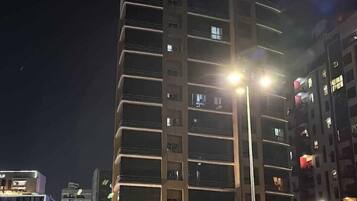 A multi-story building with a 'bench' sign at the ground level, likely a hotel or office.