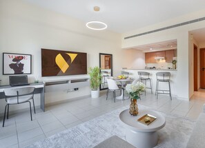Luxury Apartment | Living area | 65-inch LED TV with cable channels - Vogue | Al Dhafrah 2 Greens near Mall of Emirates (Dubai)