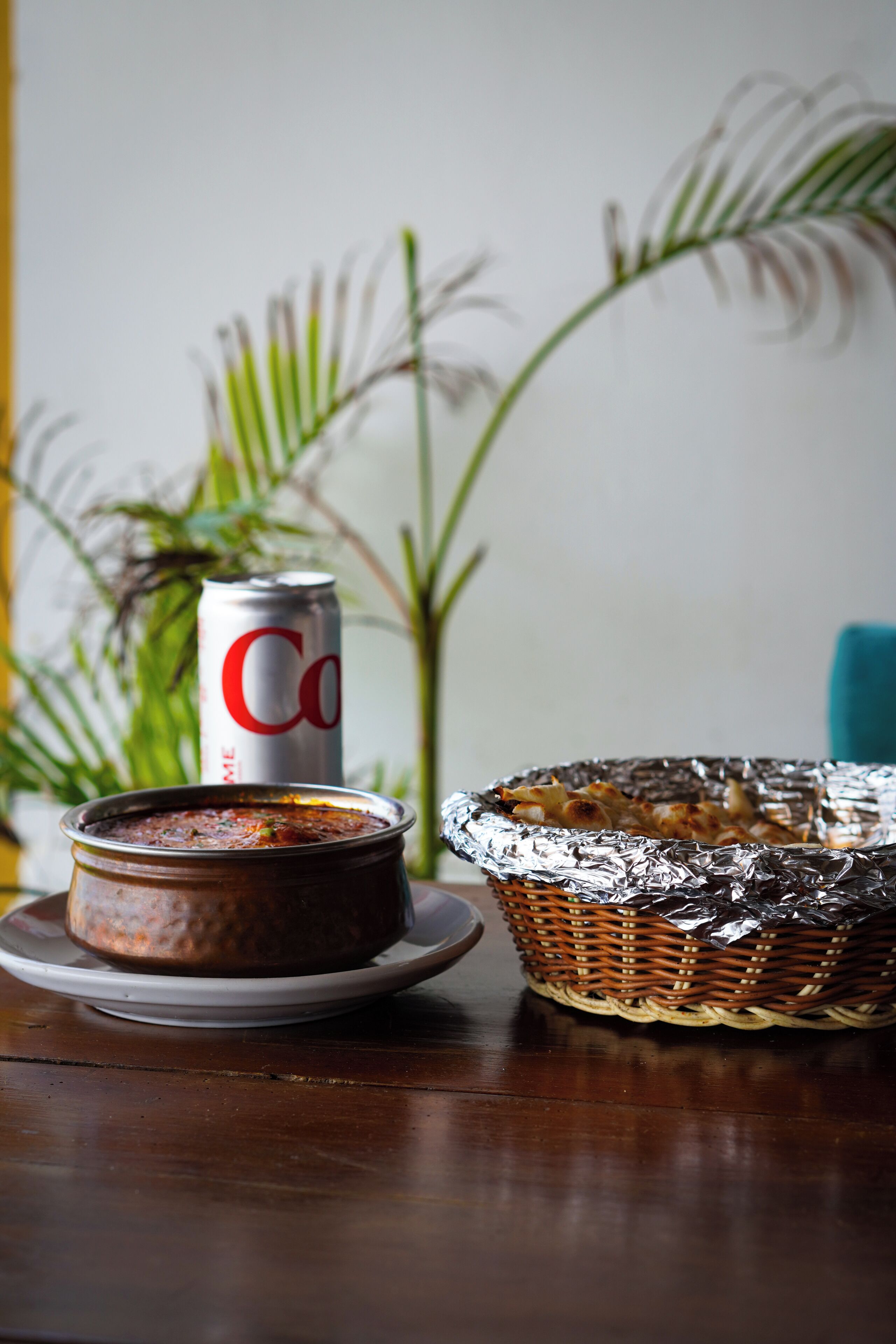 A table with a dish, a can, and a basket.