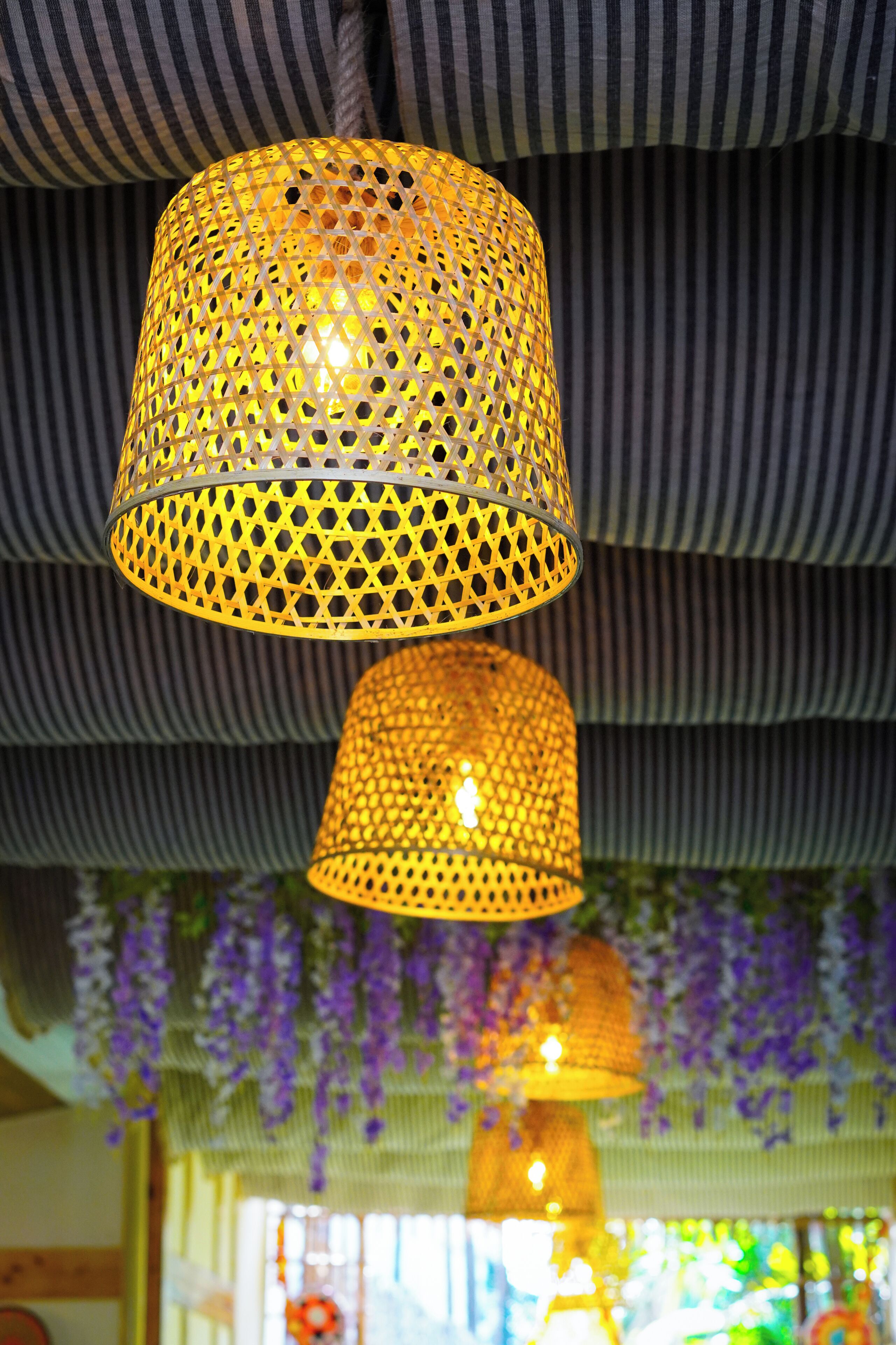A hanging lamp with a perforated metal design.