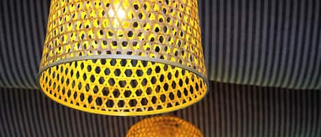 A hanging lamp with a perforated metal design.