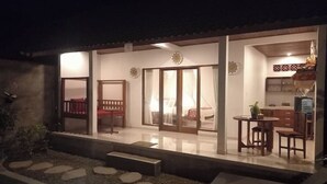 A well-lit residential space with a dining area, kitchen, and a small garden with stepping stones. - Hidden Point Villa 5 minutes to rice field walk. 1BD with Pool Walk to Ubud 

 (Bali)