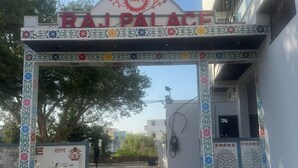 The entrance to Raj Palace with a decorative arch and floral patterns. - Raj Palace (Ajmer)