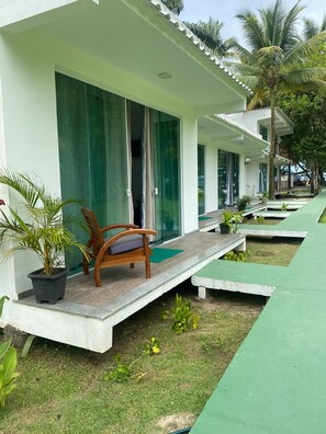 Relax on the outdoor bench amidst lush greenery and serene surroundings.