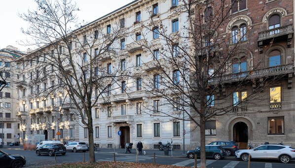 A multi-story building with classical architecture, featuring ornate balconies and large windows.