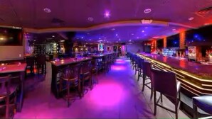 A bar area with multiple seating arrangements and a counter. - Luxe 2BR Master Suite Near NYC (East Orange)