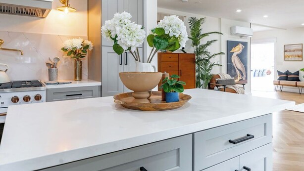 A modern kitchen with a central island, white cabinetry, and a stainless steel range hood. - Balboa Park, Zoo, Downtown! BRAND NEW (San Diego)