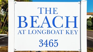 A sign for 'The Beach at Longboat Key' with the address '3465'.