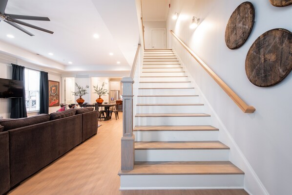 A staircase with wooden steps and a handrail, leading to a door at the top. - Watch Hill Manor | 3BR + Bonus | Norton Commons (Prospect)