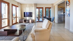 Un salón amplio con sofá, televisor y comedor.