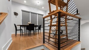 A staircase with wooden steps and metal railings, leading to an upper floor.