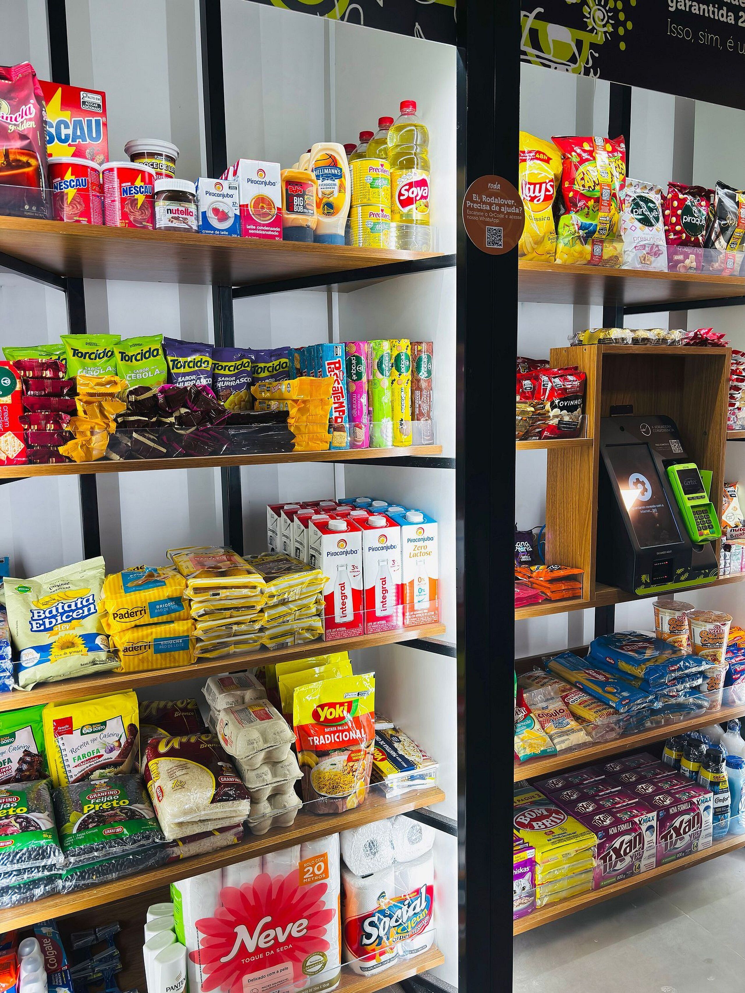 A grocery store with various food items and household products on shelves.