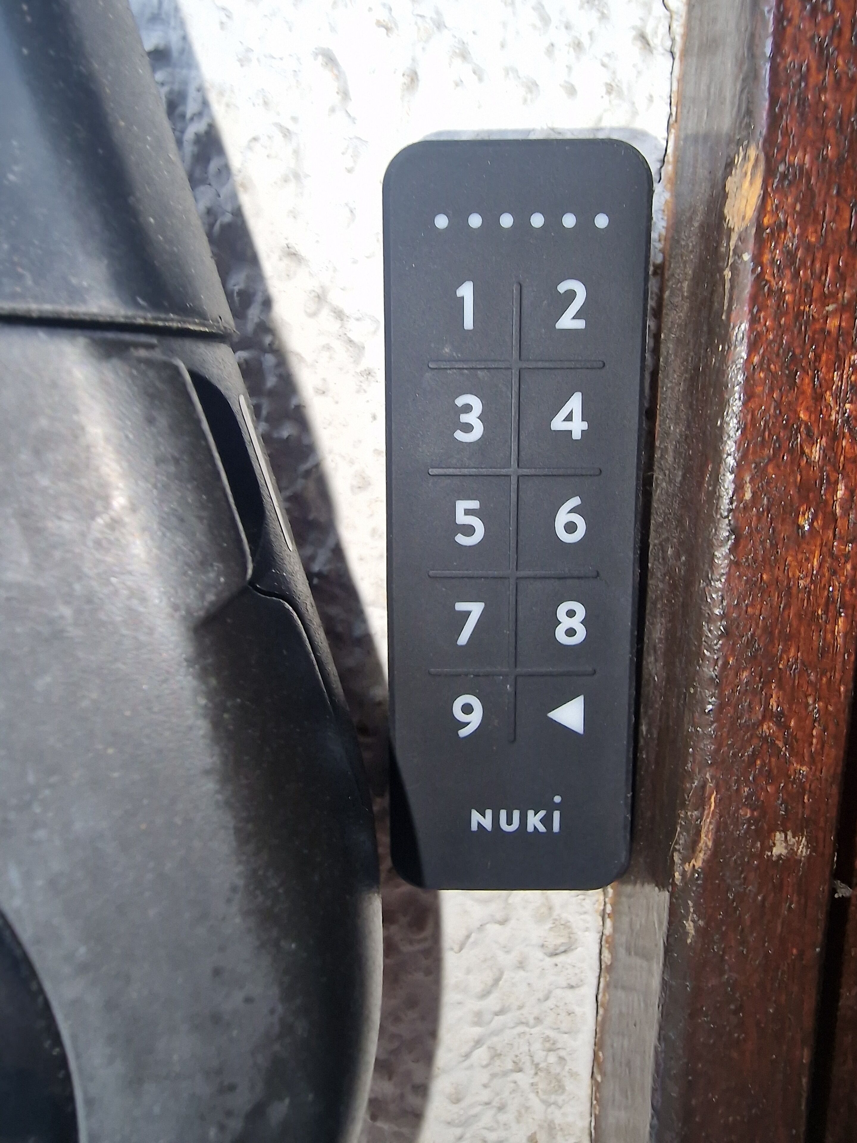 A black numeric keypad with the brand name 'NUKI' on a door.