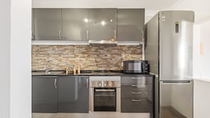 A modern kitchen with stainless steel appliances, a microwave, and a built-in oven.