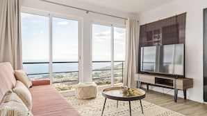 Un soggiorno moderno con un divano, un tavolino e una TV.
