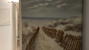 A painting of a beach scene with a wooden fence. - Colwins #2 For Families/Couples/Singles Sleeps 4 (Cockburn Town)