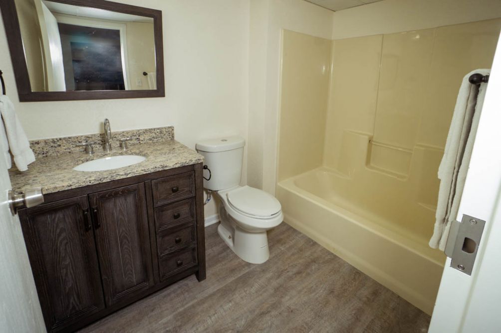 A bathroom with a sink, toilet, and bathtub.