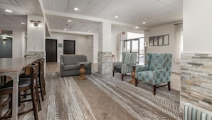 A spacious living area with a sofa, armchairs, and a dining table. - Trendy Studio Haven at Oak Ridge in Branson (Branson)