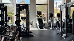A gym with various exercise equipment, large windows, and a wooden ceiling. - Resort living in Scottsdale w heated pool #124 (Scottsdale)
